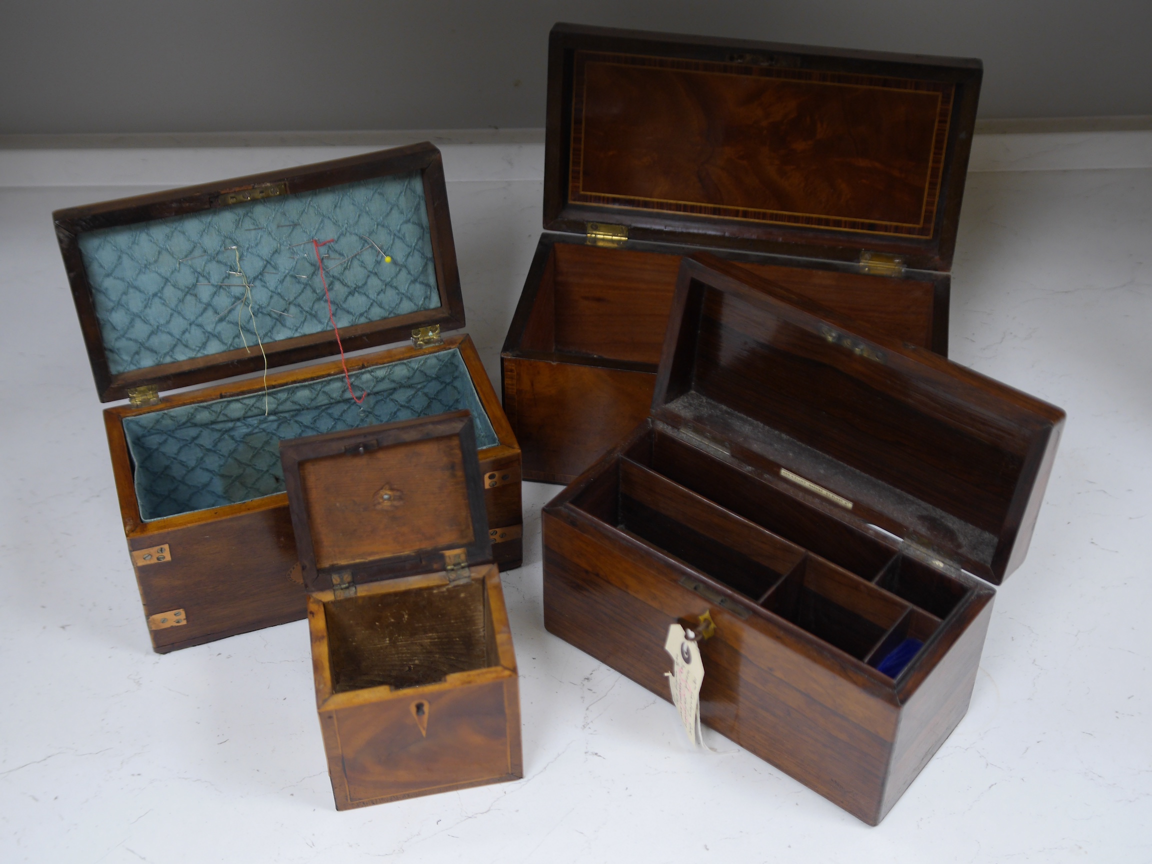 An early 19th century inlaid tea caddy, two sewing boxes and a stationery box, 25.5cm x 14cm various. Condition - stationery box good, others have some damage